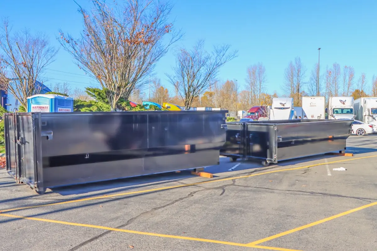 Professional dumpster rental service with roll-off container on residential driveway in Claremont